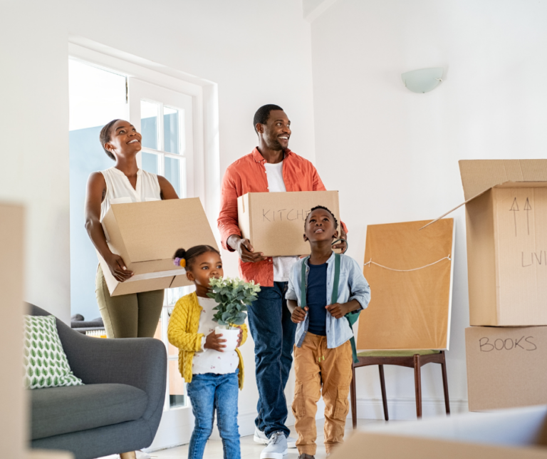 Happy family moving into a new home after preparing their credit score for renting or buying a home