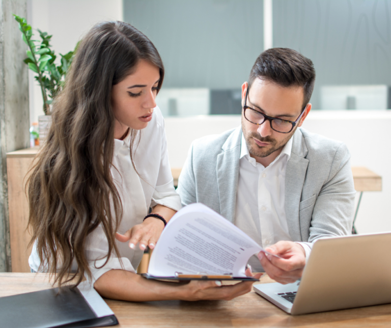 Two professionals reviewing documents together to dispute credit report errors